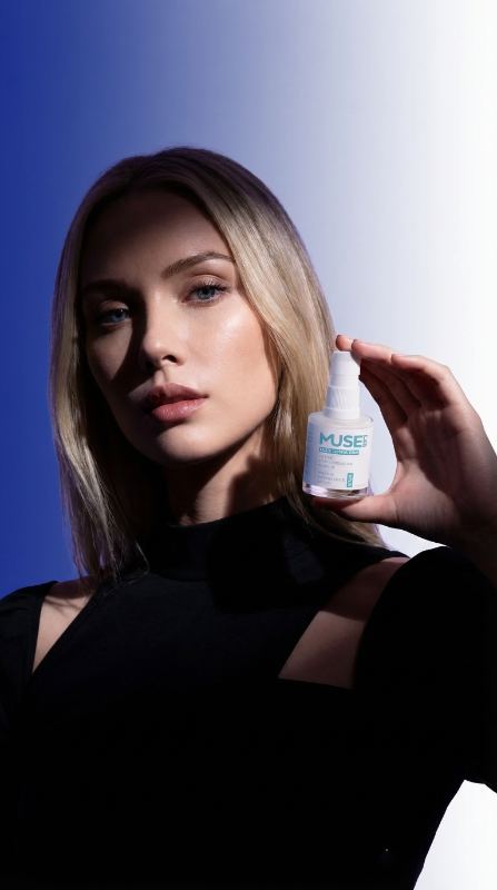 Muse Lab — model against blue holding blush
